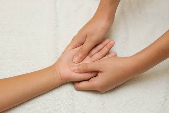 A hand getting massaged